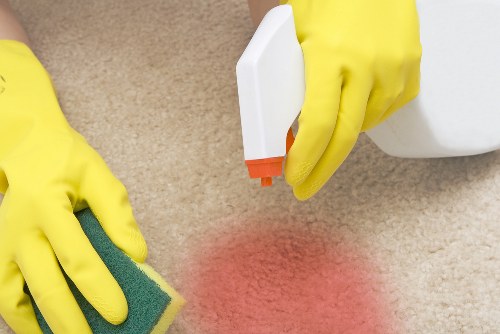 Professional carpet cleaners working in an N8 home with deep cleaning equipment