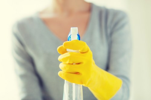 Office cleaning team sanitising desks and meeting areas in N8